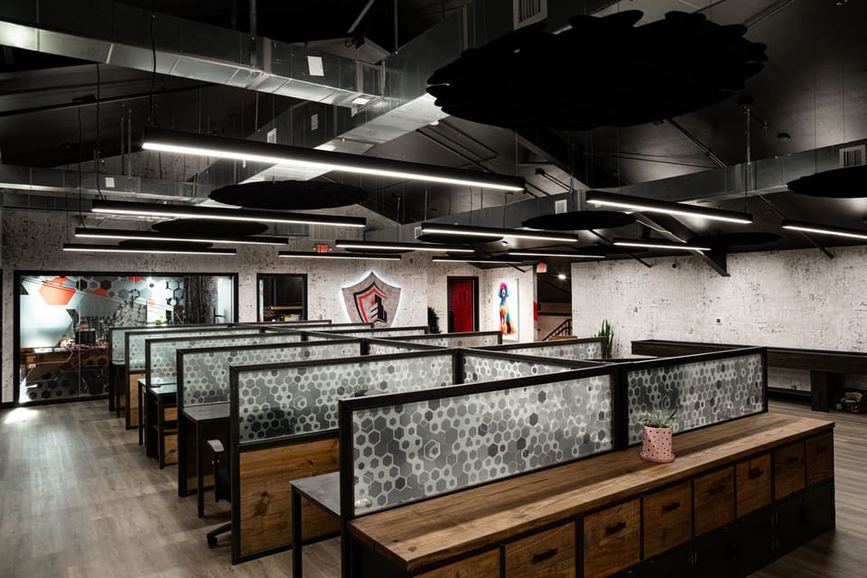 Long bench desks with frosted hexagon-pattern film on the glass panels