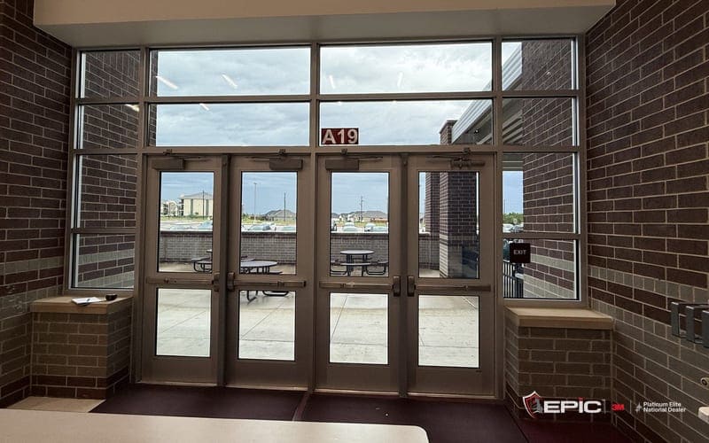 School glass doors seen straight on from inside — the window film visualizer