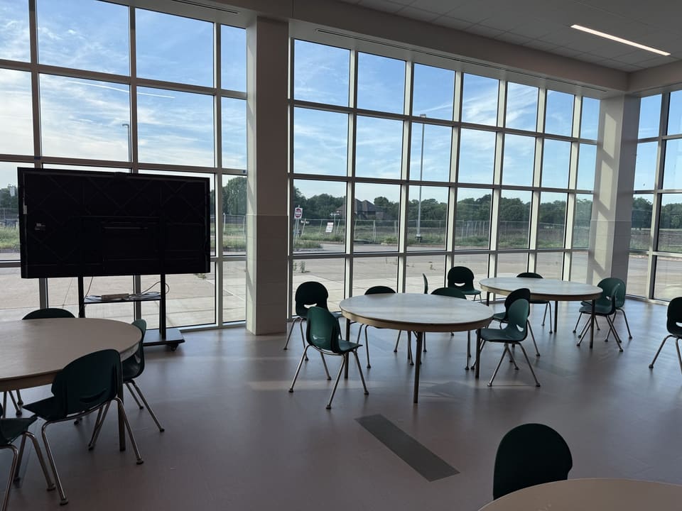 School cafeteria with a two-story curtainwall of glass, filmed by Epic
