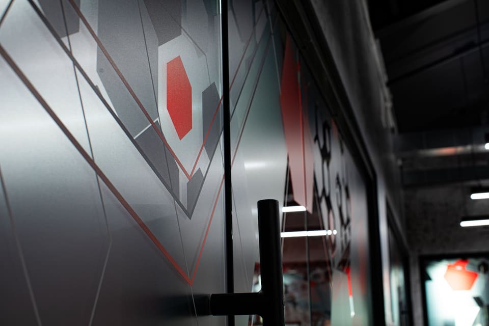 Close view of frosted and red geometric graphics on a glass office door