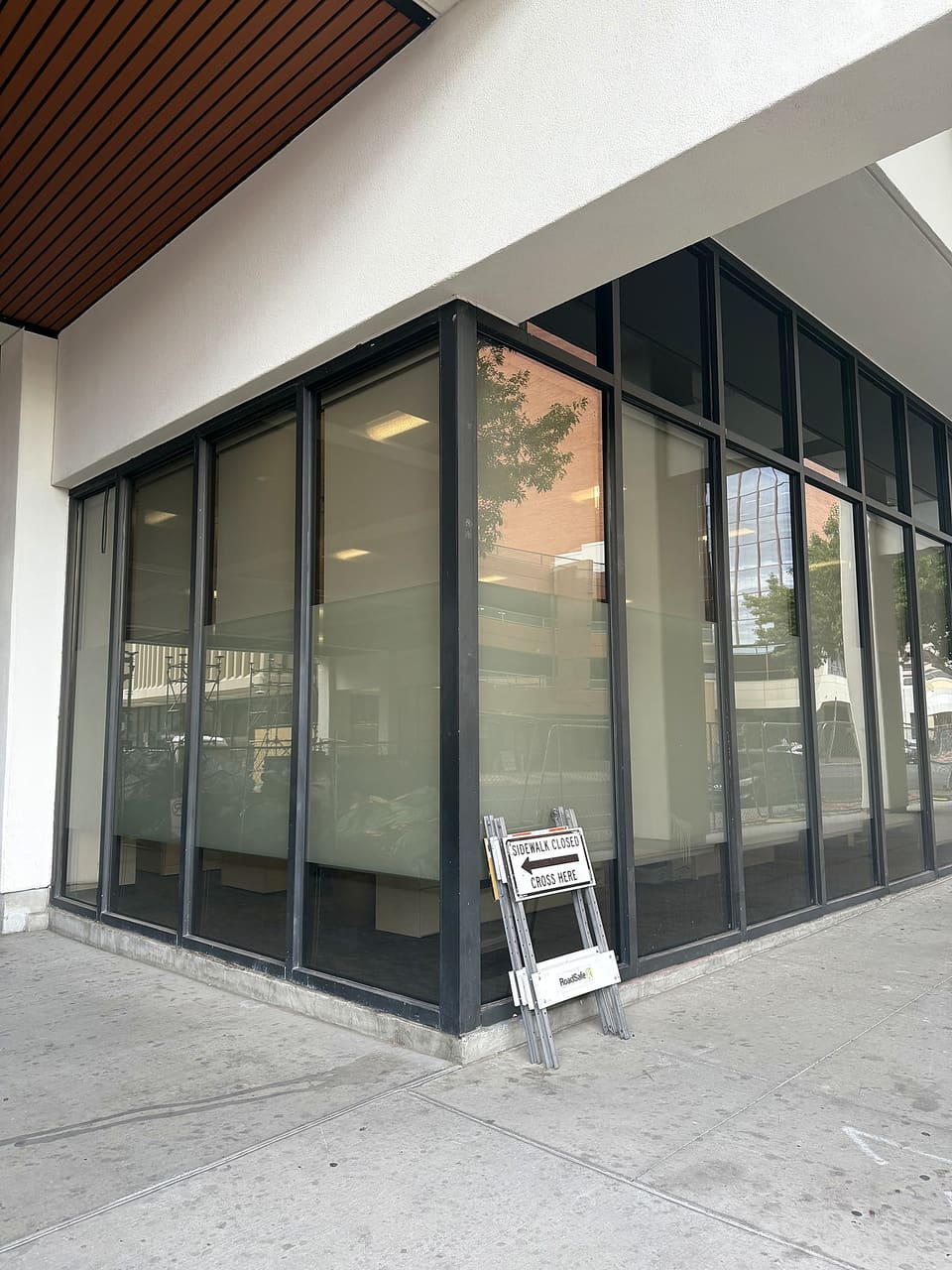 Street view of the corner glass with the frost band — the security film is invisible