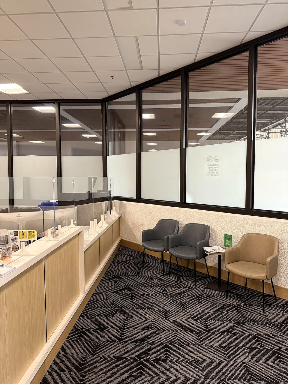 Public counter and waiting area with the frost band continuing across the perimeter glass