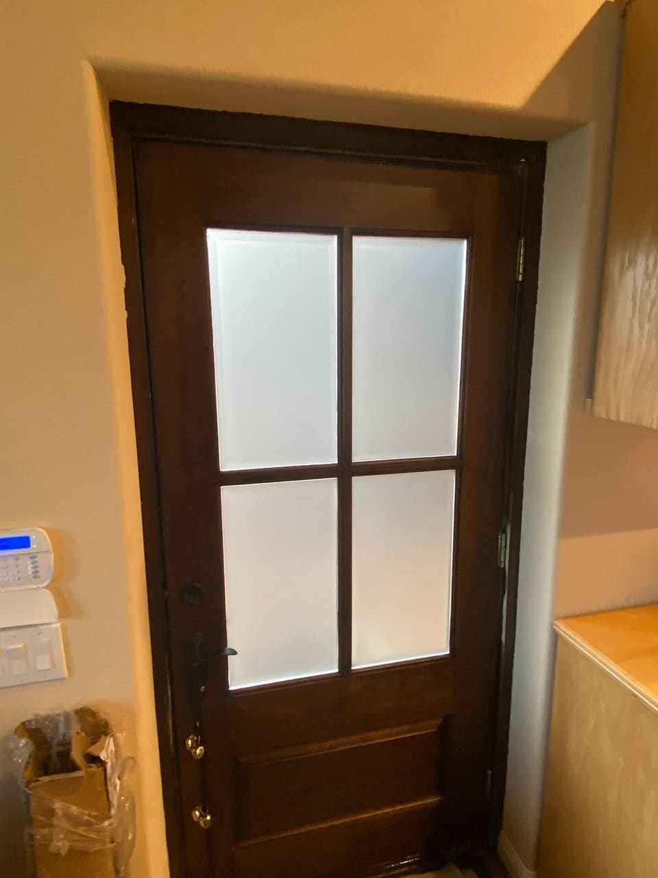 Wood door with four glass lites covered in frosted privacy film