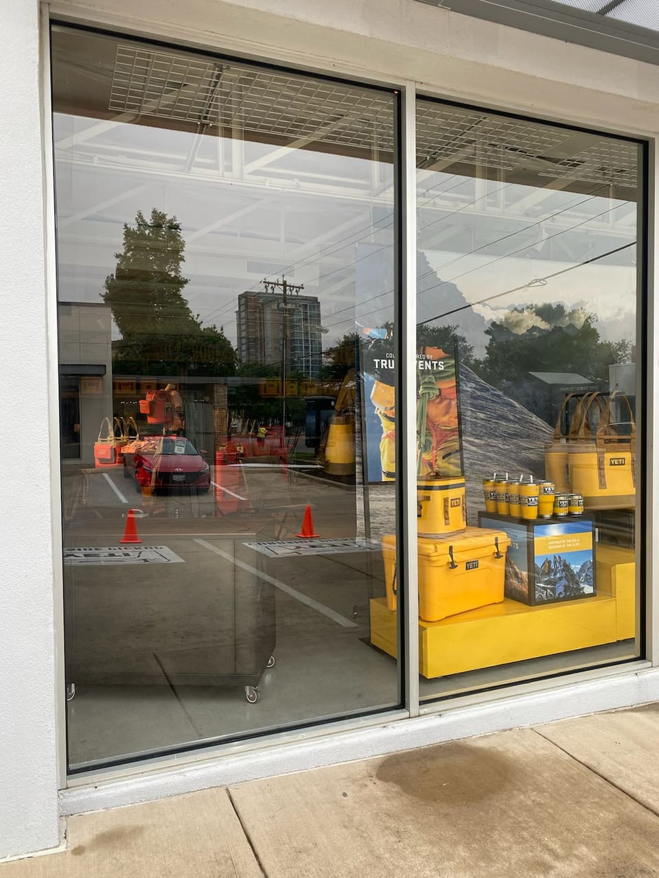 Close view of the storefront glass with a yellow and orange display behind it